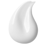A white droplet of cream being smeared upwards.